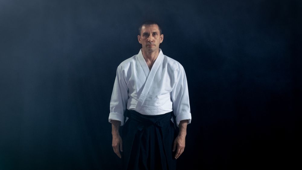 Portrait Shot of the Aikido Master Wearing Traditional Samurai Hakama Clothes Looking into Camera.