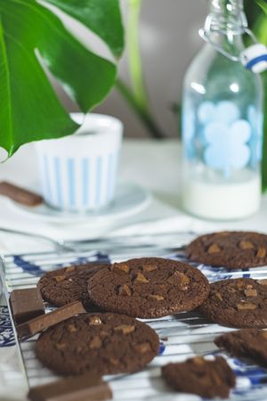 Chocolate cookies with milk in the background
