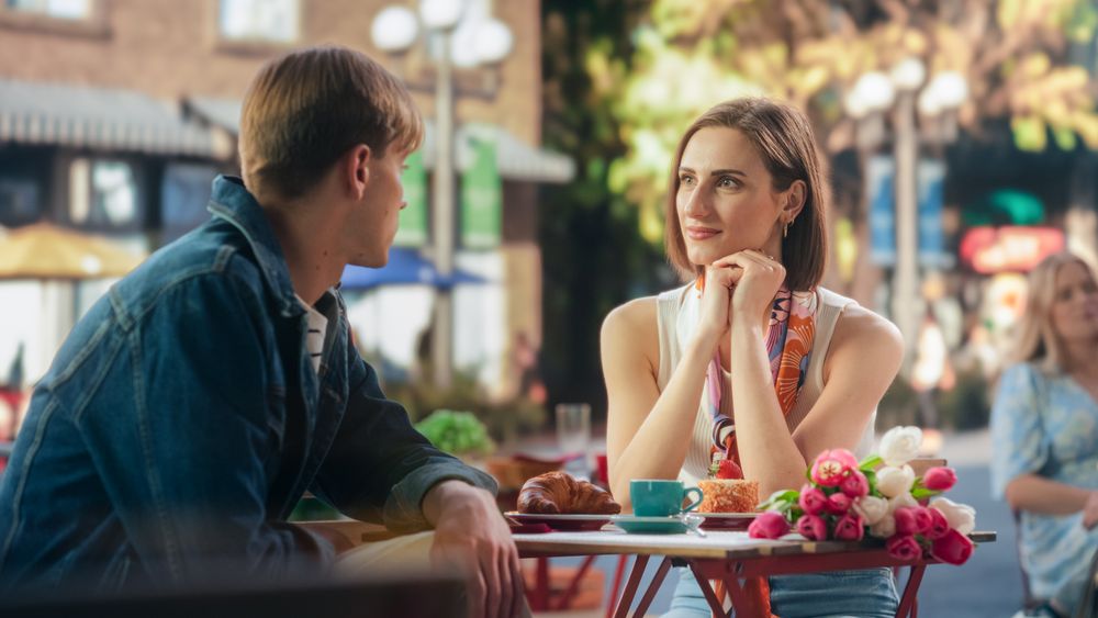 Young Man and Woman Meeting at a Restaurant, Having a Carefree Date on a Terrace.
