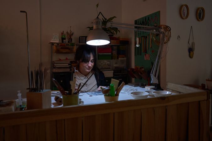 Female jeweler working in workshop