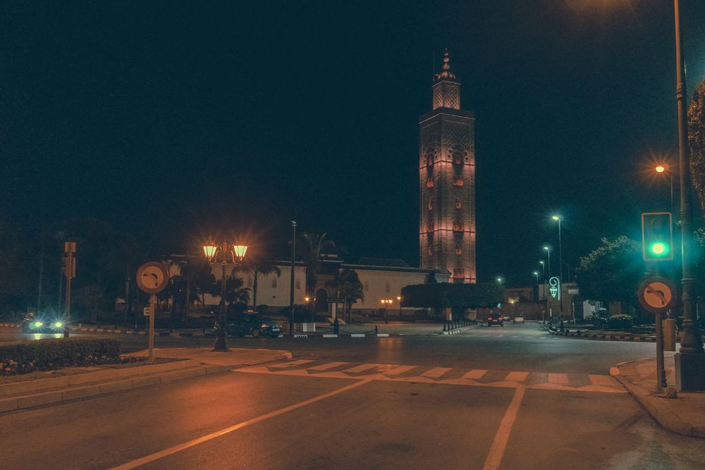 Road on street near high tower at night