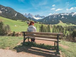 woman admiring the views of Small beautiful village between mountains with snow