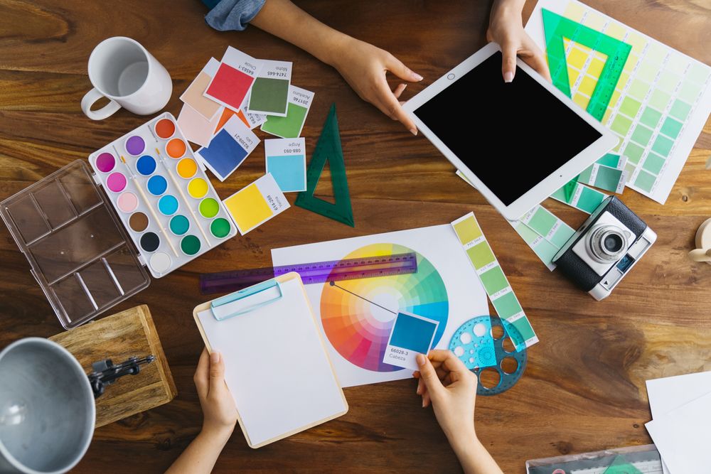 Top view of artists working on desk