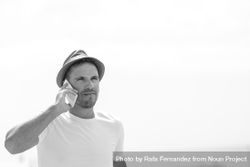 Monochrome shot of male speaking on phone outside 43YKV0