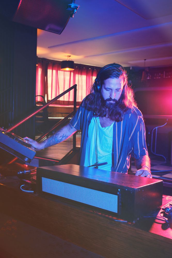 Man playing music at DJ setup