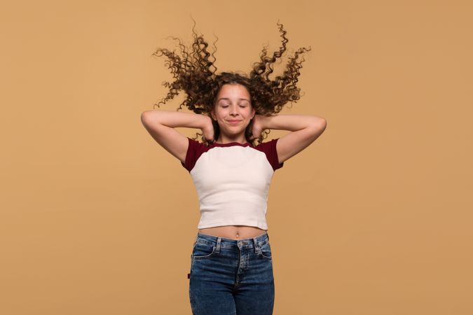 Girl with hair flying upwards, eyes closed, expressing calmness
