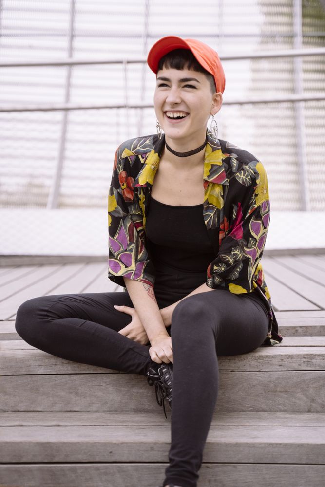 Women in colorful shirt sitting on street