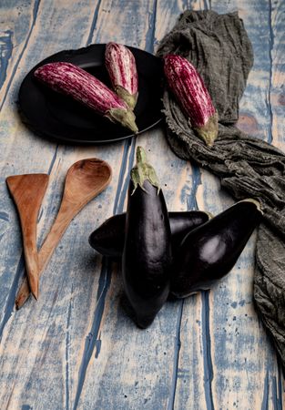 Ripe eggplants on shabby tabletop