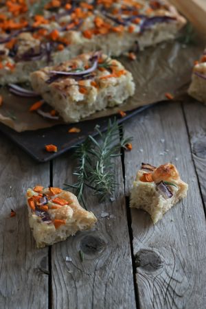 Pieces of fresh focaccia on wooden table