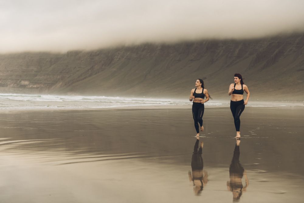 Anonymous women running near sea