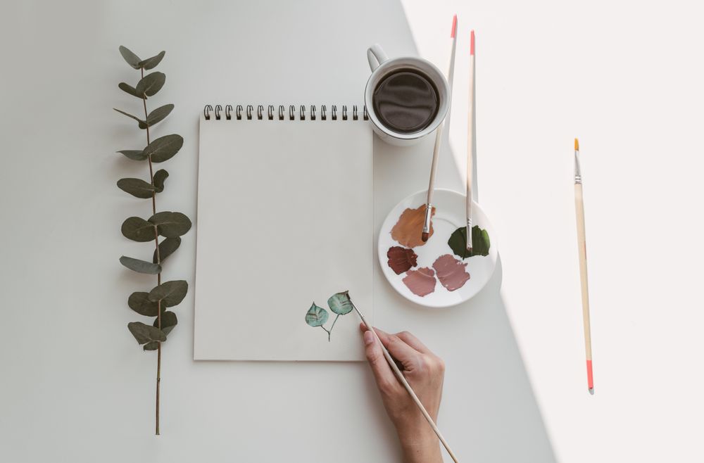 Person drawing flowers with watercolor