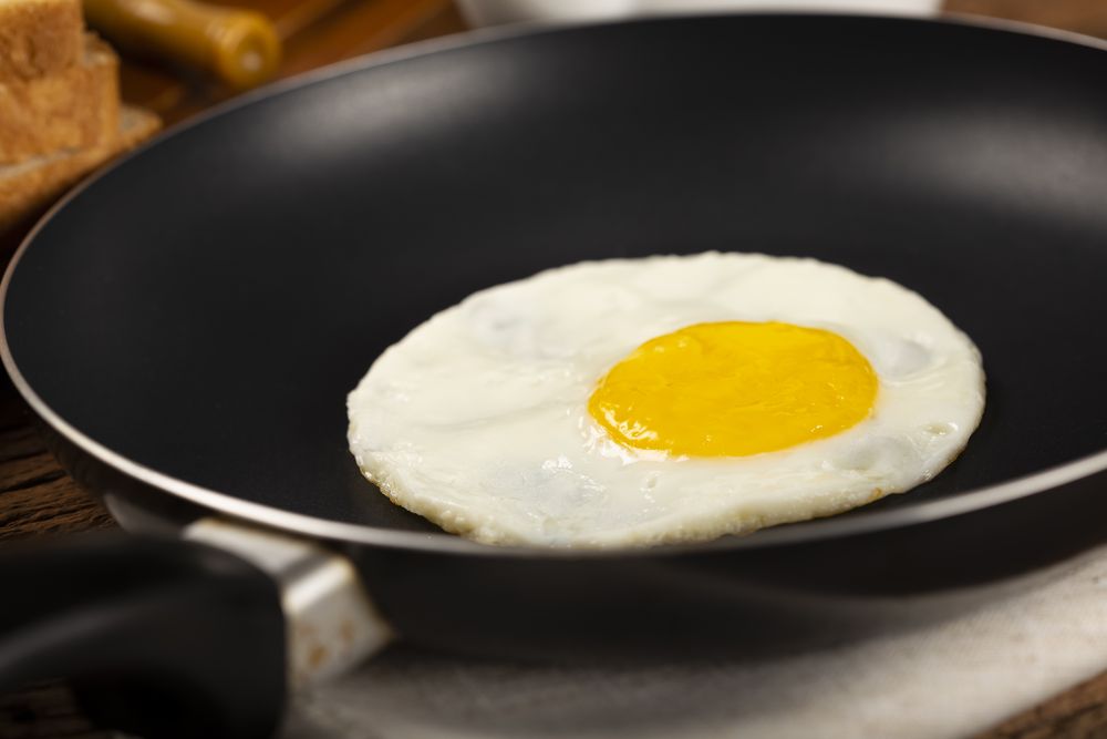 Breakfast with fried egg in the frying pan.