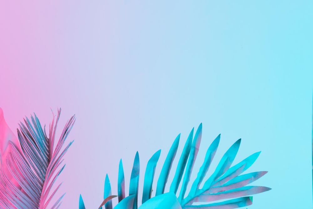 Tropical and palm leaves in vibrant bold gradient holographic colors