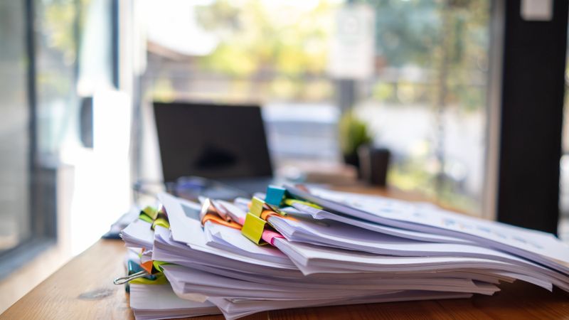 A huge stacked documents is an annual earnings summary document prepared for business