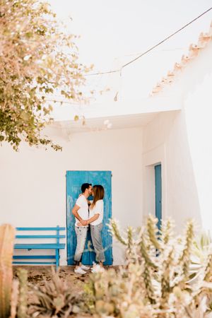 Loving couple cuddling near beach house