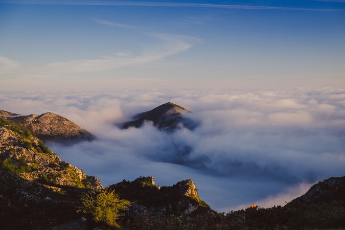 Wonderful view of blue sky above thick clouds in valley from mountain