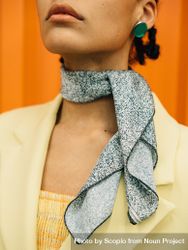 Cropped image of woman wearing yellow blazer and gray scarf 5XAVG4
