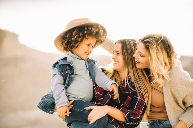 Smiling blond women walking with curly child