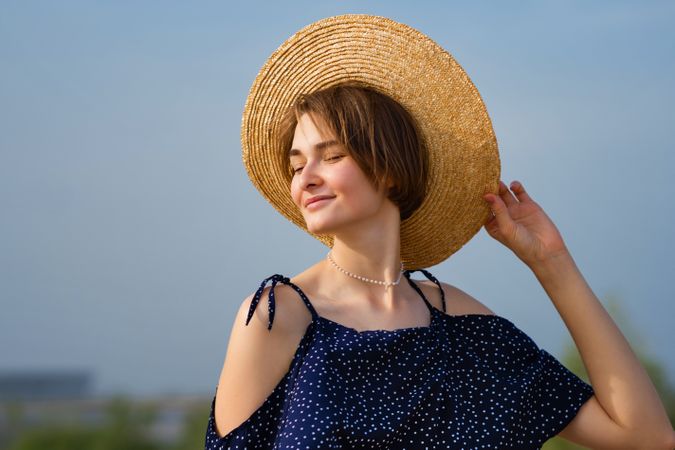 Young woman in straw hat outdoors