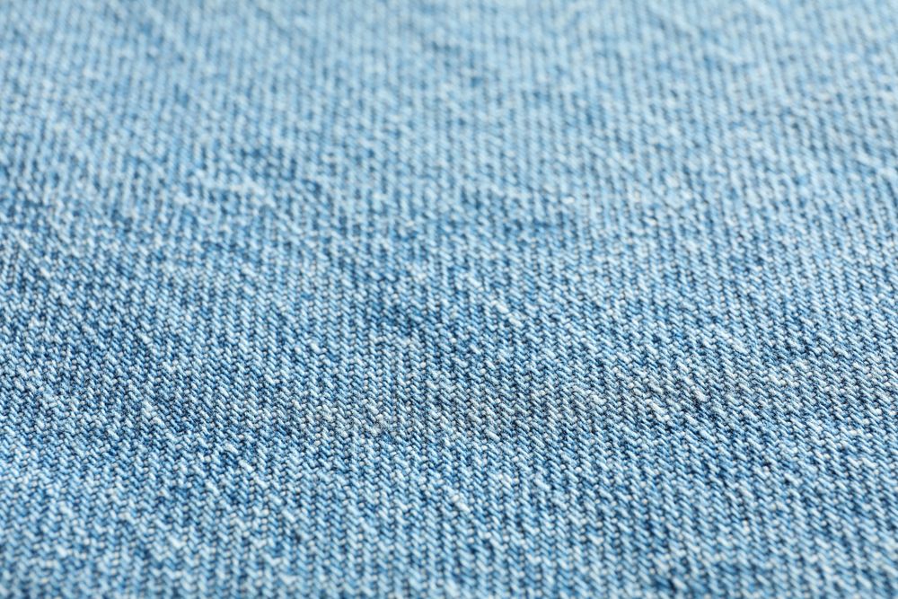Texture of blue jeans as background, space for text
