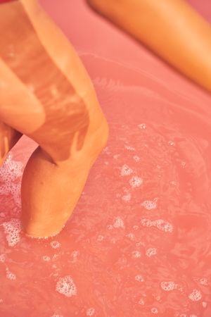 female in swimwear walking in pink salty water