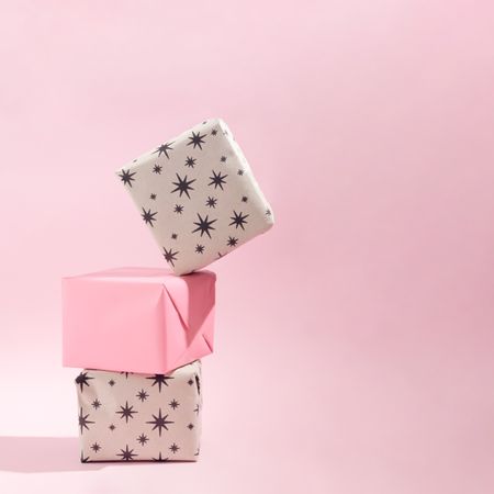 Christmas present concept idea on soft pink background with shadow