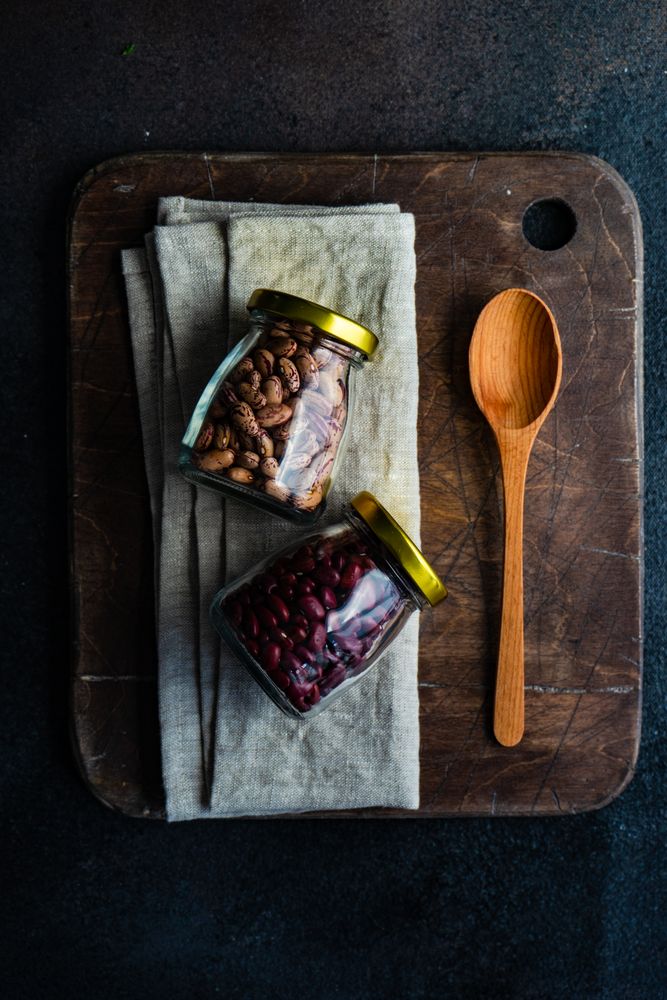 Two jars of dried beans on kitchen counter