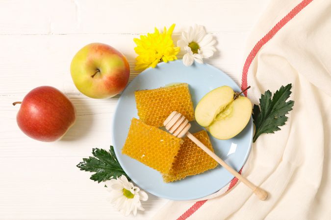 Honey, flowers and apples on wooden background, copy space