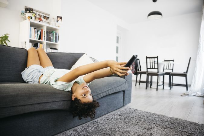 Girl watching tv in living room