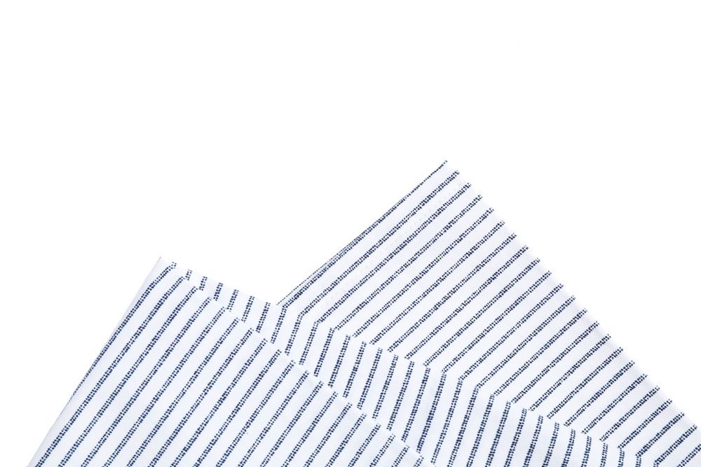 Folded fabric napkin isolated on plain background