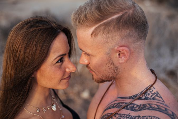 Cool dreamy couple in swimwear on shore