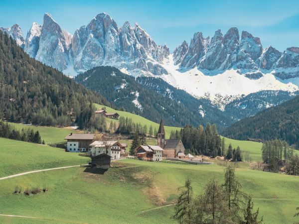 Small beautiful village between mountains with snow