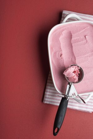 Strawberry ice cream tray with a scoop