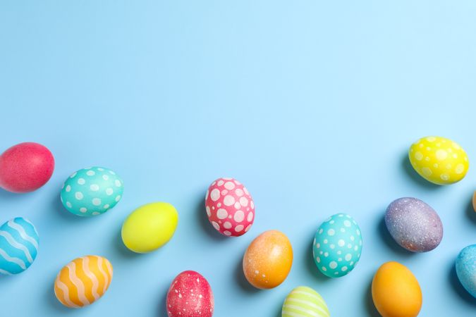 Flat lay composition with Easter eggs on color background, space for text. Top view