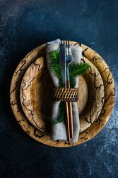 Rustic Christmas table setting with decorative fir wrapped with cutlery