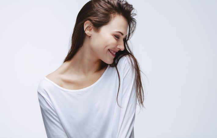 Beautiful woman in white top smiling