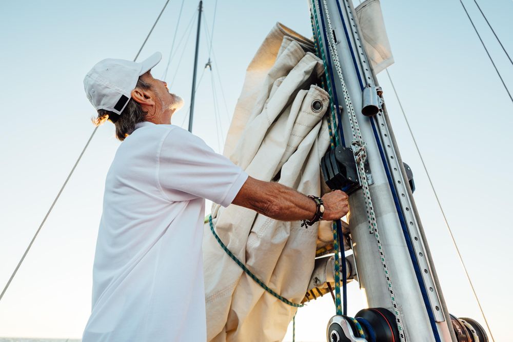 Man setting the sail on a boat