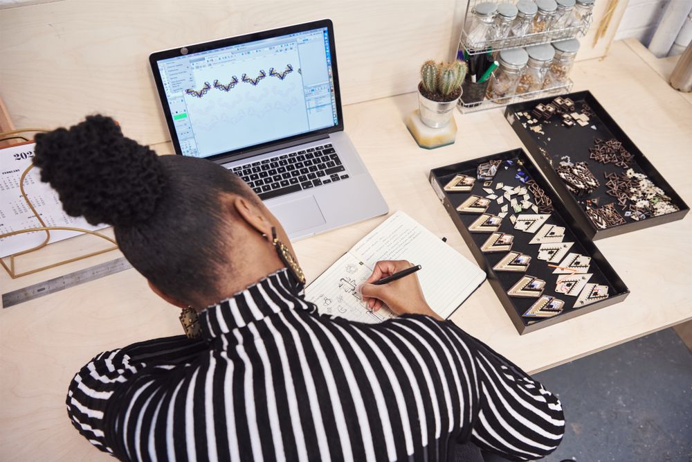 Jewelry designer sketching in her notebook