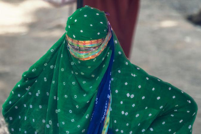 Woman in green and blue Niqab