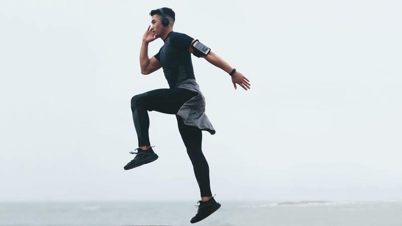 Sporty asian man doing jump exercise