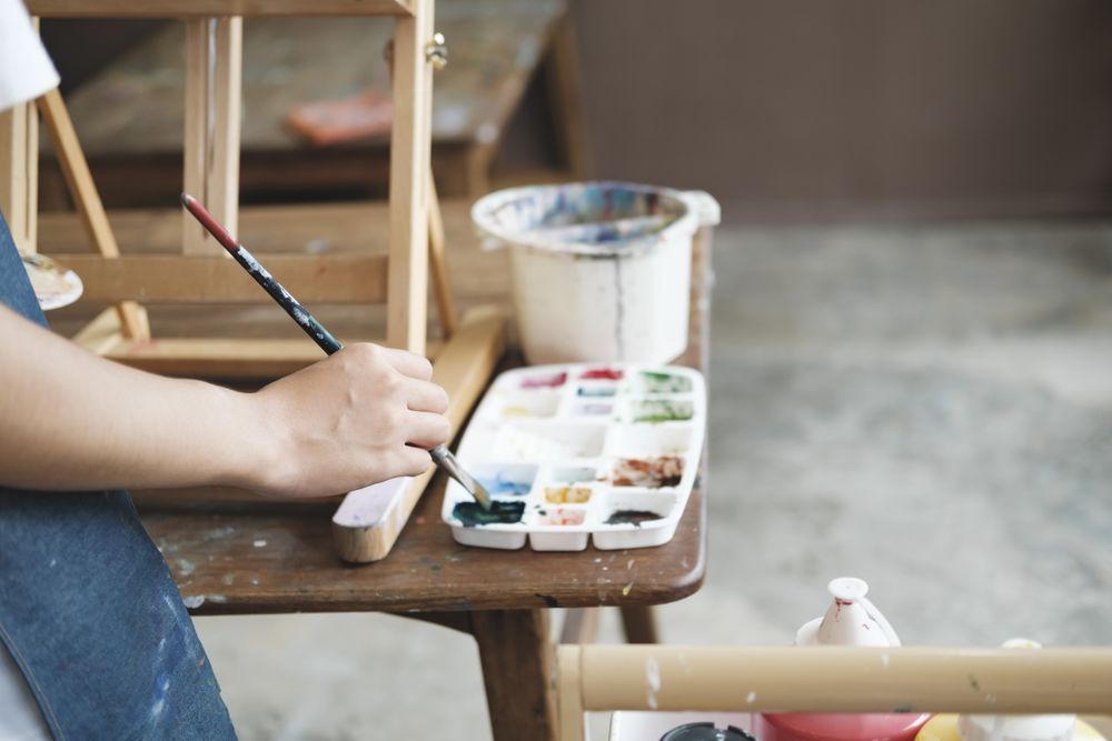 Crafting Inspiration: Female Artist Sketching and Painting in Workshop