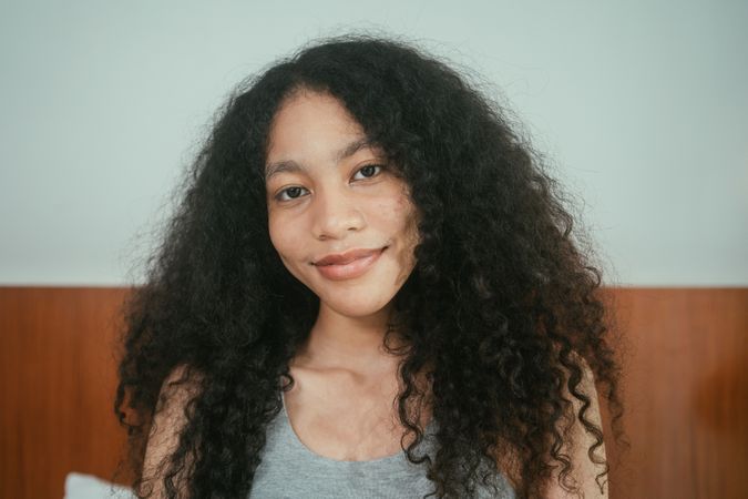 Curly hair woman smiling to camera