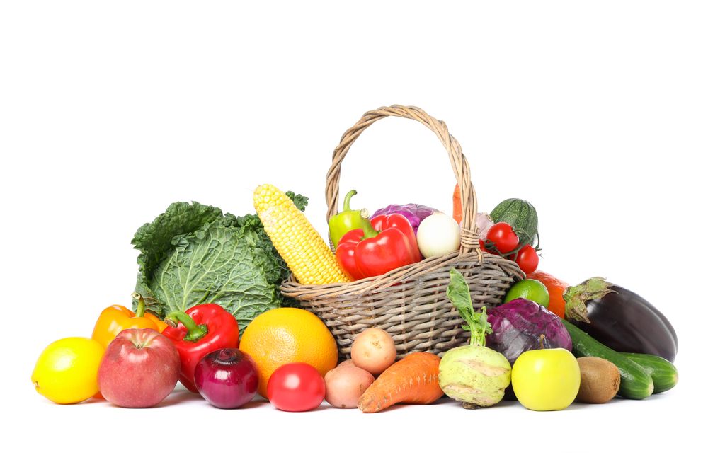 Wicker basket and different vegetables isolated on blank background
