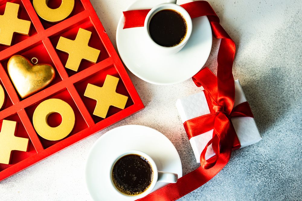 Top view of St. Valentine day card concept with present and two cups of espresso