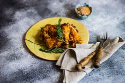 Grilled chicken with rosemary with napkin and silverware