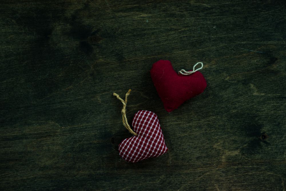 Valentine's day concept of thatched heart decorations on wooden table with copy space