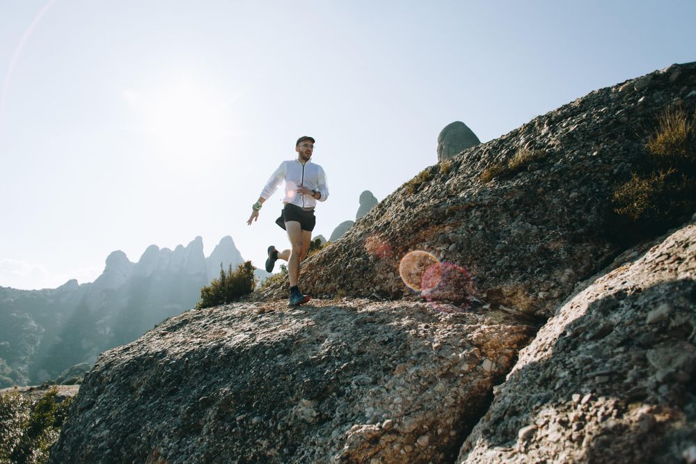 Action shot of man running on a hill
