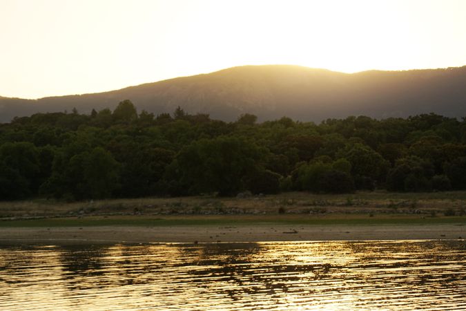 Picturesque view of lake with countryside route, fir forest and hills in Valmayor lake Spain