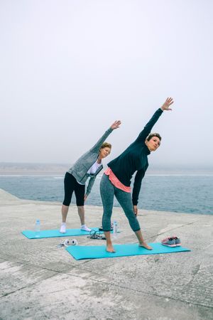 Mature woman with coach stretching side