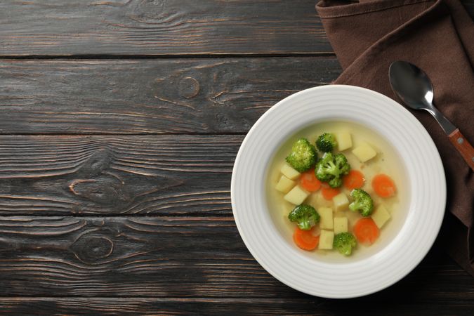 Potato, carrot and broccoli soup on table, with copy space